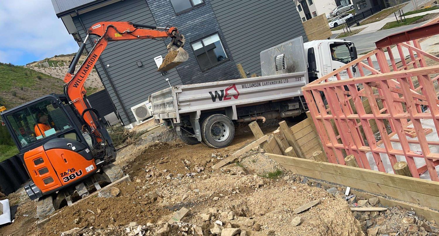 Company mini excavator loading spoil into the Williamson Earthmoving tipper truck